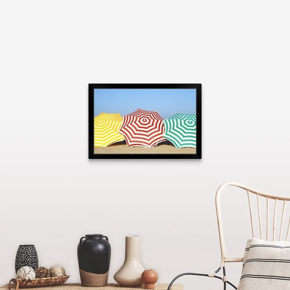 "Colorful umbrellas on beach" Black Framed Print